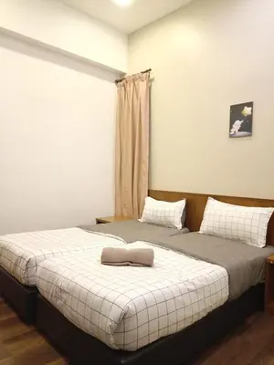 two beds sitting next to each other in a room at Bayt Rizq Homestay 3R2B in Brinchang