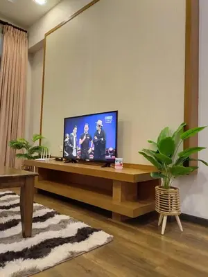 a living room with a television on a table at Bayt Rizq Homestay 3R2B in Brinchang