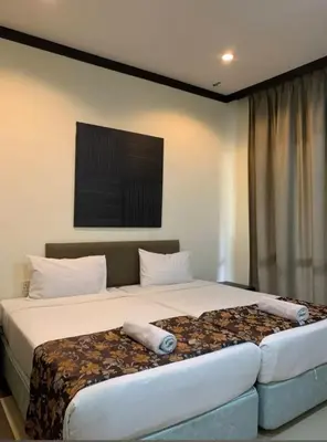 a bedroom with a bed with two pillows on it at Eds Hot Spring Villa's in Sungkai