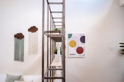 a spiral staircase in a living room next to a wall at Georgetown Heritage 1F stay 10pax 3BR in George Town