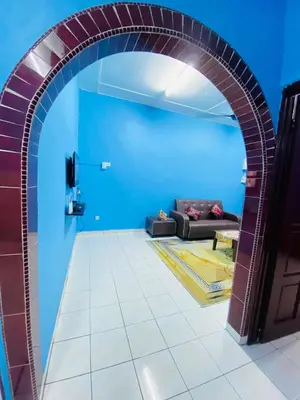 an archway leading into a living room with a couch at Homestay Sayang in Ipoh
