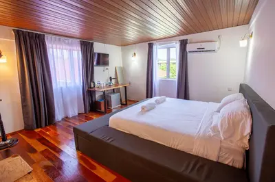 a bedroom with a large bed in a room at Joe Fisherman Inn in Pangkor