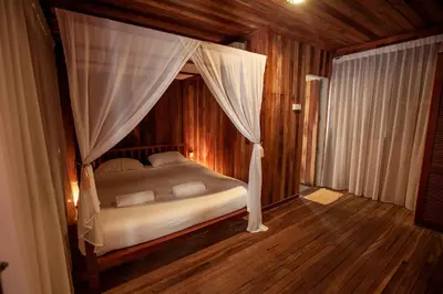 a bedroom with a bed with a canopy at Joe Fisherman Inn in Pangkor