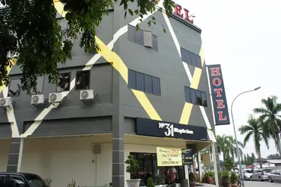 a building with a yellow stripe on the side of it at No.31 Maple Inn in Simpang Ampat