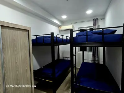 three bunk beds in a room with blue pillows at Marvel Nest- 3bedroom-Poolview-10pax in Bukit Mertajam