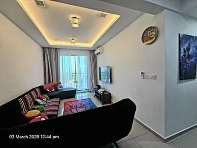 a living room with a couch and a tv at Marvel Nest- 3bedroom-Poolview-10pax in Bukit Mertajam