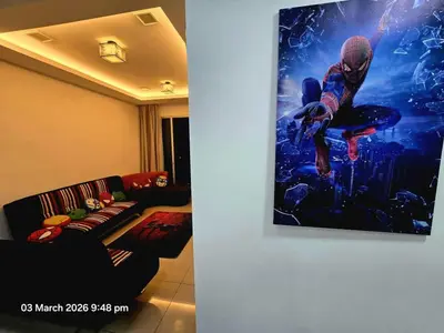 a living room with a couch and a picture on the wall at Marvel Nest- 3bedroom-Poolview-10pax in Bukit Mertajam