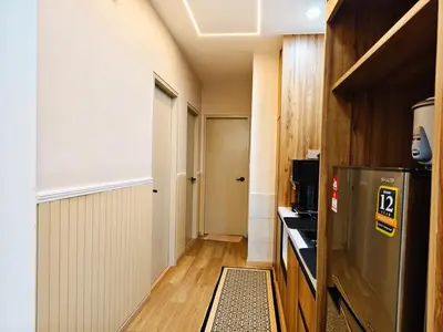 a small kitchen with a refrigerator in a room at DG HomestayMuslim Piccadilly Ipoh Pool View in Ipoh