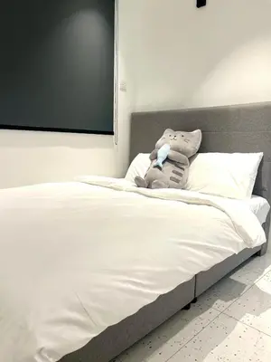 a bed with a stuffed animal on top of it at Casa for 8 ipoh Central Pet Allowed in Ipoh