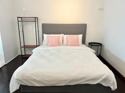a bedroom with a large bed with pink pillows at Casa for 8 ipoh Central Pet Allowed in Ipoh