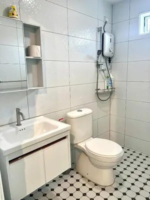a white bathroom with a toilet and a sink at Casa for 8 ipoh Central Pet Allowed in Ipoh