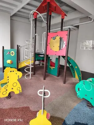 a childrens play room with a playground with a slide at Straits Garden Penang 2BR in Jelutong