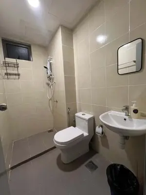 a bathroom with a toilet and a sink at Shahiqa Palas Horizon Residence in Cameron Highlands