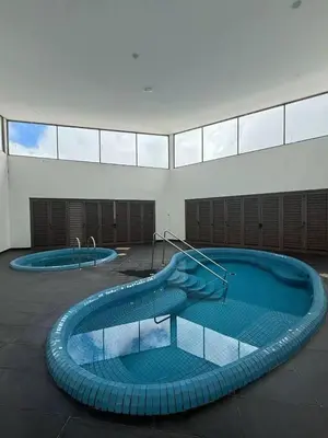 a large swimming pool in a building with two swimming pools at Shahiqa Palas Horizon Residence in Cameron Highlands