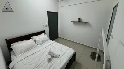 a bedroom with a bed with white sheets and pillows at ModernNest-V1-PS5-sleep10 in Bukit Mertajam