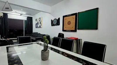 a living room with a table and chairs and a chalkboard at ModernNest-V1-PS5-sleep10 in Bukit Mertajam