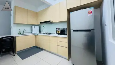 a kitchen with a refrigerator and a table in it at ModernNest-V1-PS5-sleep10 in Bukit Mertajam