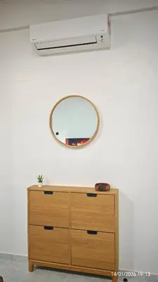 a mirror on a wall above a dresser with a dresser at Homestay Si Manja Kini Bertam 4 Bilik Semi D 2 Tingkat in Kepala Batas