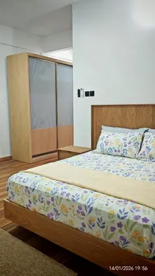 a bedroom with a bed with a wooden headboard at Homestay Si Manja Kini Bertam 4 Bilik Semi D 2 Tingkat in Kepala Batas