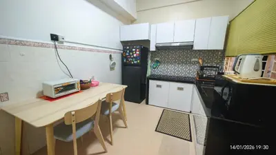 a small kitchen with a table and a microwave at Homestay Si Manja Kini Bertam 4 Bilik Semi D 2 Tingkat in Kepala Batas