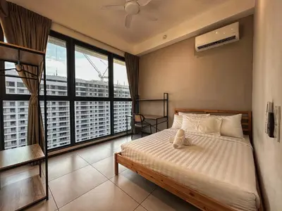 a bedroom with a bed with a view of a city at Le Jardin Suite 8 Pax Sea View Infinity Pool in George Town