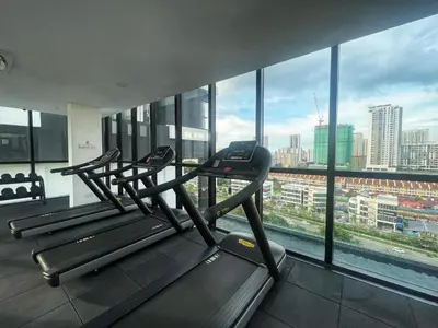 a gym with three treadmills in front of a large window at Le Jardin Suite 8 Pax Sea View Infinity Pool in George Town