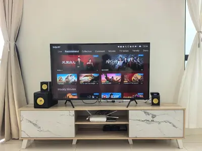 a flat screen tv sitting on top of a entertainment center at Batu Kawan Sunset Seaview Condo near Ikea & Design Village in Batu Kawan