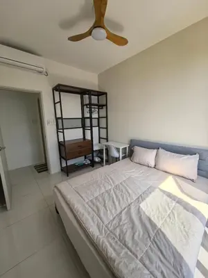 a bedroom with a bed and a ceiling fan at Batu Kawan Sunset Seaview Condo near Ikea & Design Village in Batu Kawan