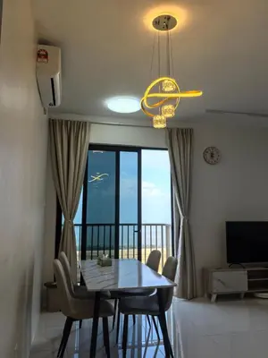 a dining room with a table and chairs and a chandelier at Batu Kawan Sunset Seaview Condo near Ikea & Design Village in Batu Kawan