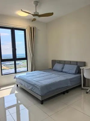 a bedroom with a bed and a ceiling fan at Batu Kawan Sunset Seaview Condo near Ikea & Design Village in Batu Kawan