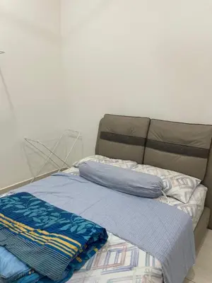a bed with two pillows on top of it at Nafisa Homestay in Kepala Batas