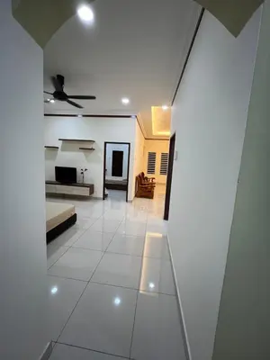 a living room with white walls and a ceiling at KK Homestay Ipoh in Ipoh