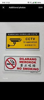 a sign that says no smoking and a no smoking sign at Tasek Cermin Roomstay in Ipoh