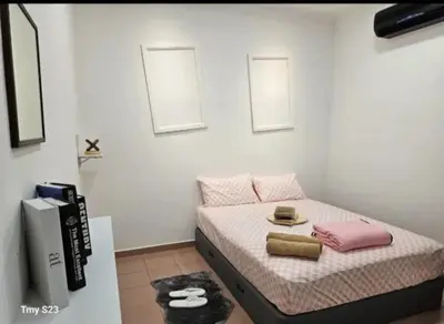 a bedroom with a bed with two towels on it at Tasek Cermin Roomstay in Ipoh