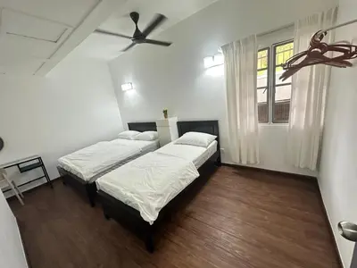 two beds in a room with a ceiling fan at Fraser's Haven SilverparkResort Walk down 8 steps in Bukit Fraser