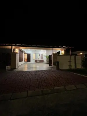 a night view of a house with a patio at KK Homestay Ipoh in Ipoh