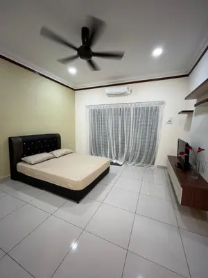 a bedroom with a bed and a ceiling fan at KK Homestay Ipoh in Ipoh