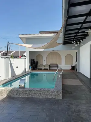 a swimming pool in front of a house at Villa SRC in Sungai Petani