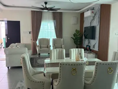 a living room with a table and chairs at Villa SRC in Sungai Petani