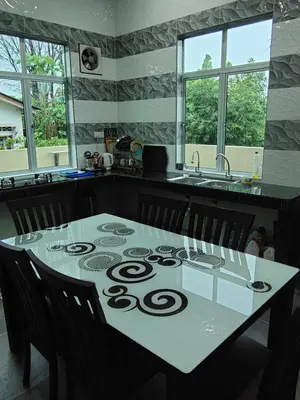 a kitchen with a table with a number on it at SUN HOMESTAY Teluk Intan