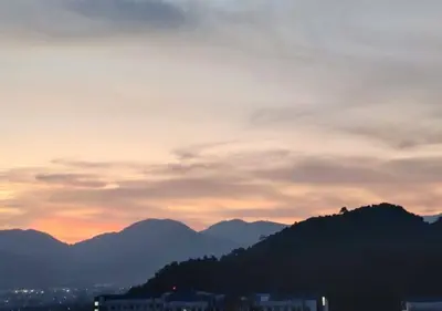 a sunset with mountains in the background at Horizon Skyline Loft in Ipoh