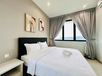 a bedroom with a white bed and a window at Romantic Sea & Penang Bridge View Luxury 2BR in Bayan Lepas