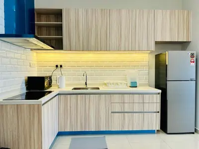 a kitchen with a sink and a refrigerator at Romantic Sea & Penang Bridge View Luxury 2BR in Bayan Lepas