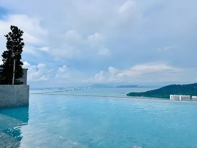 a swimming pool with a view of the ocean at dream sweet home bayan lepas iconic netflix usm in Bayan Lepas