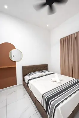 a bedroom with a bed and a ceiling fan at Villa Natura ByTheNook in Sungai Petani