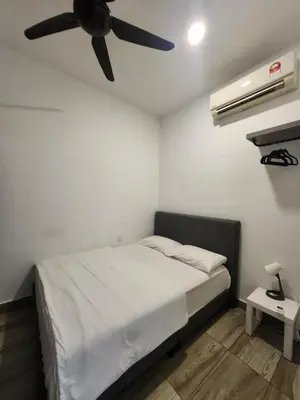 a bedroom with a bed with a ceiling fan at The Octagon Ipoh - City Centre Premium Stay in Ipoh