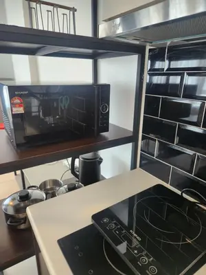 a microwave oven sitting on a counter in a kitchen at The Octagon Ipoh - City Centre Premium Stay in Ipoh