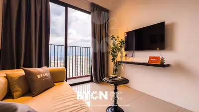 a living room with a couch and a large window at Piccadilly Premium Suites Ipoh by BYON in Ipoh