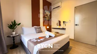 a bedroom with a bed and a door to a bathroom at Piccadilly Premium Suites Ipoh by BYON in Ipoh