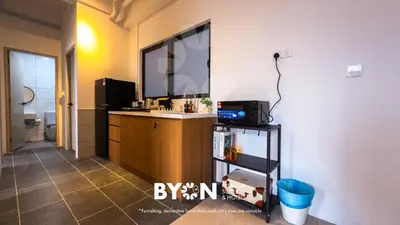 a bathroom with a sink and a large mirror at Piccadilly Premium Suites Ipoh by BYON in Ipoh